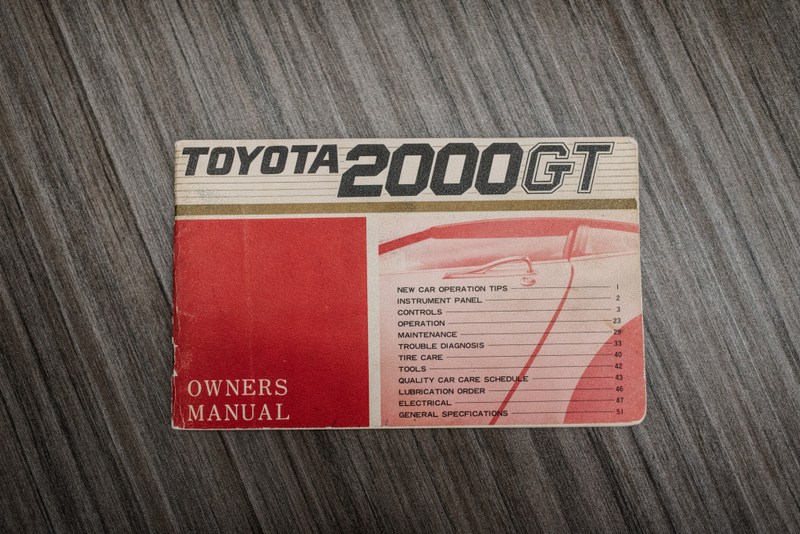 Illustration for article titled Hey, Let's Rob Some Banks To Buy This Perfect Left-Hand-Drive Toyota 2000GT